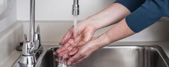 Hands being washed at a sink