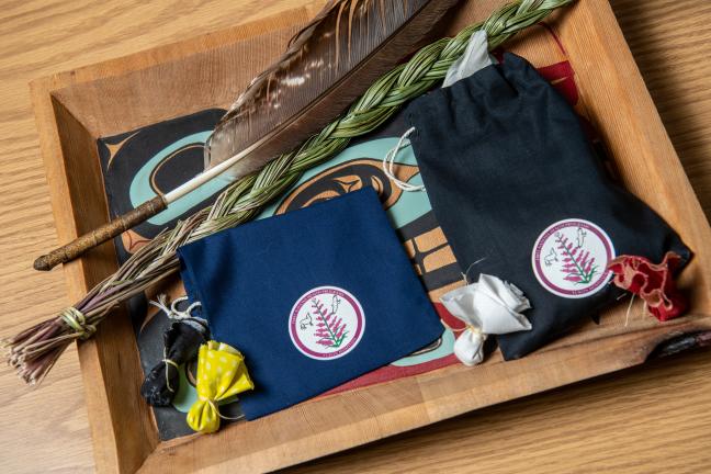 A tray of sweet grass, feathers and pouches in First Nations Health Programs. 