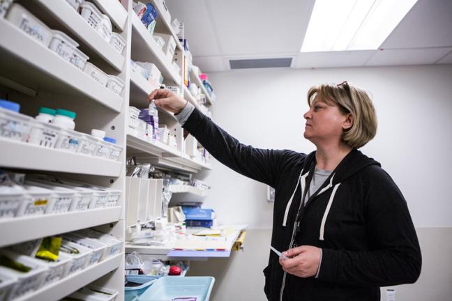 A pharmacy employee organizes medications at the Whitehorse General Hospital Pharmacy.