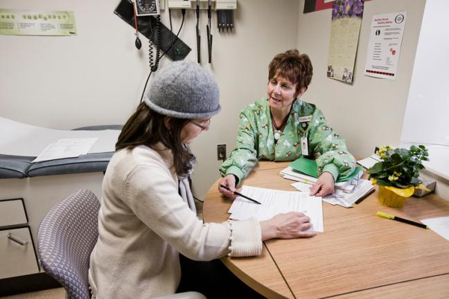 A patient meets with a staff member before their elective surgery. 