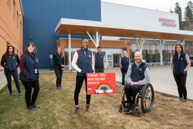 Members of the Whitehorse General Hospital Volunteer Services Team pose outside the hospital. 