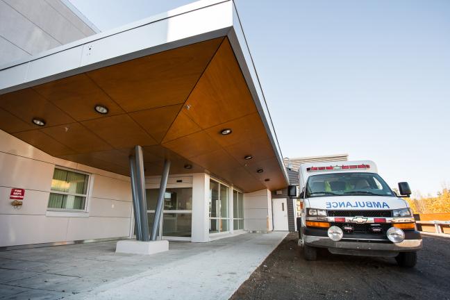 An ambulance parked outside the Watson Lake Community Hospital Emergency Department.