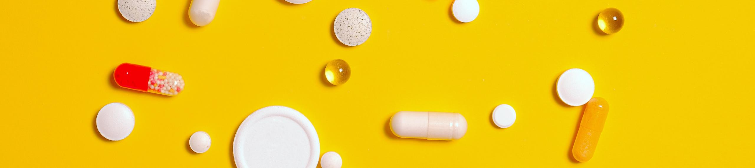 Medication Pills on Yellow Surface